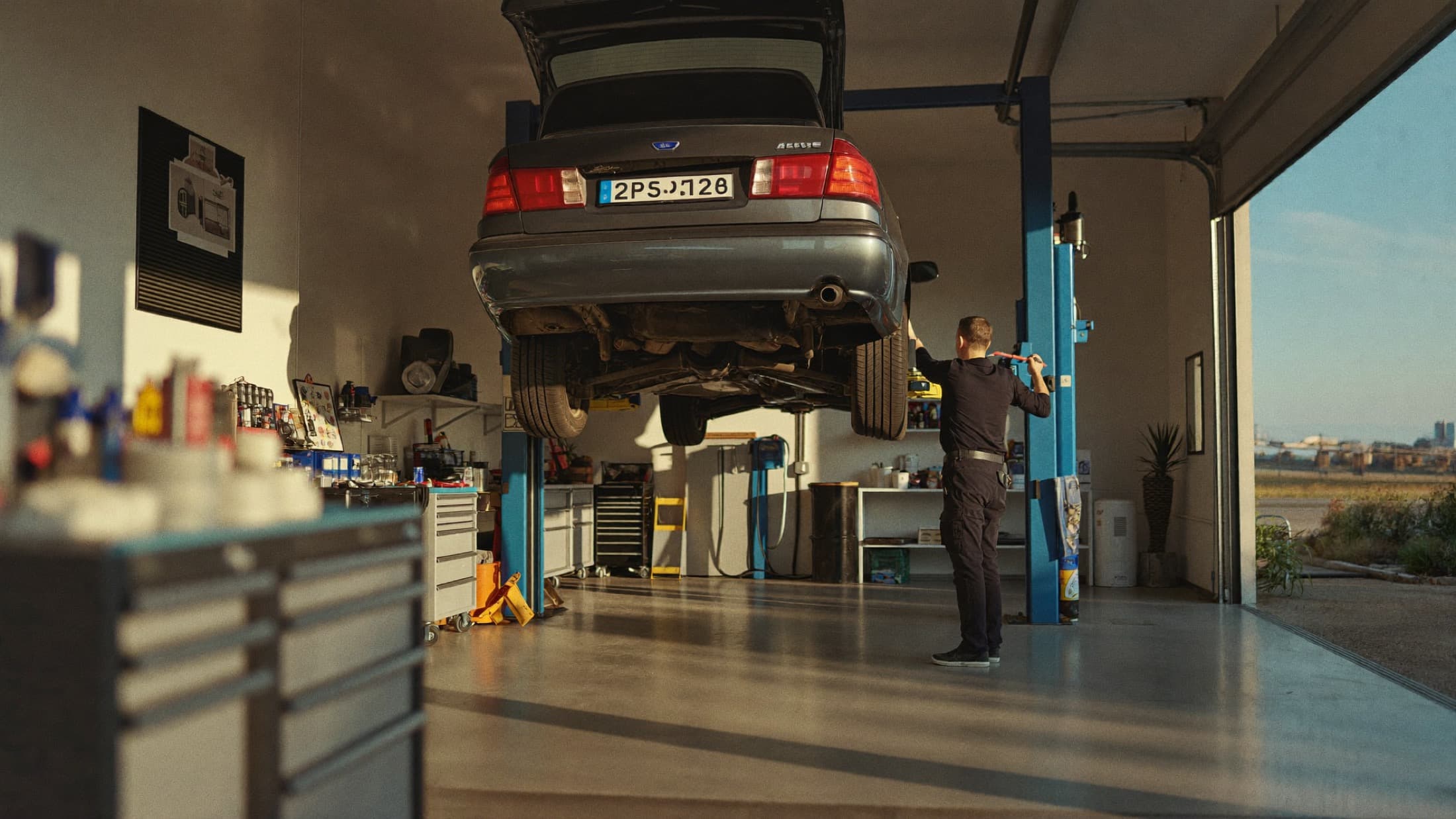 A car raised on the lift inside the Accurate Auto Center service bay